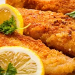 Southern Fried Fish: Irresistible Crispy, Soulful, and Simple to Make 5 Close-up of crispy Southern Fried Fish whiting fillets with a golden-brown crust, garnished with fresh parsley and lemon wedges.