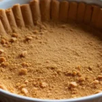 Gluten Free Graham Cracker Crust Recipe That Actually Works 6 Gluten free graham cracker crust in a white pie dish, ready for filling.