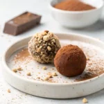 The Ultimate Guide to Perfect Gluten Free Chocolate Truffles 9 A close-up of two perfect homemade gluten free chocolate truffles, one with cocoa powder and one with nuts.
